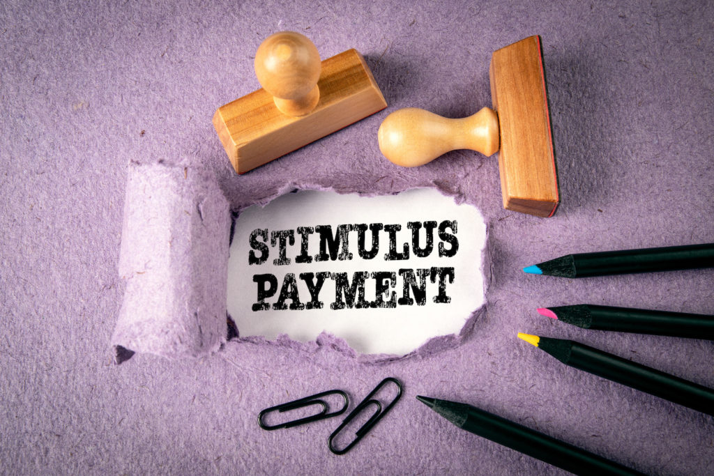 illustration with wooden stamps "stimulus payment"